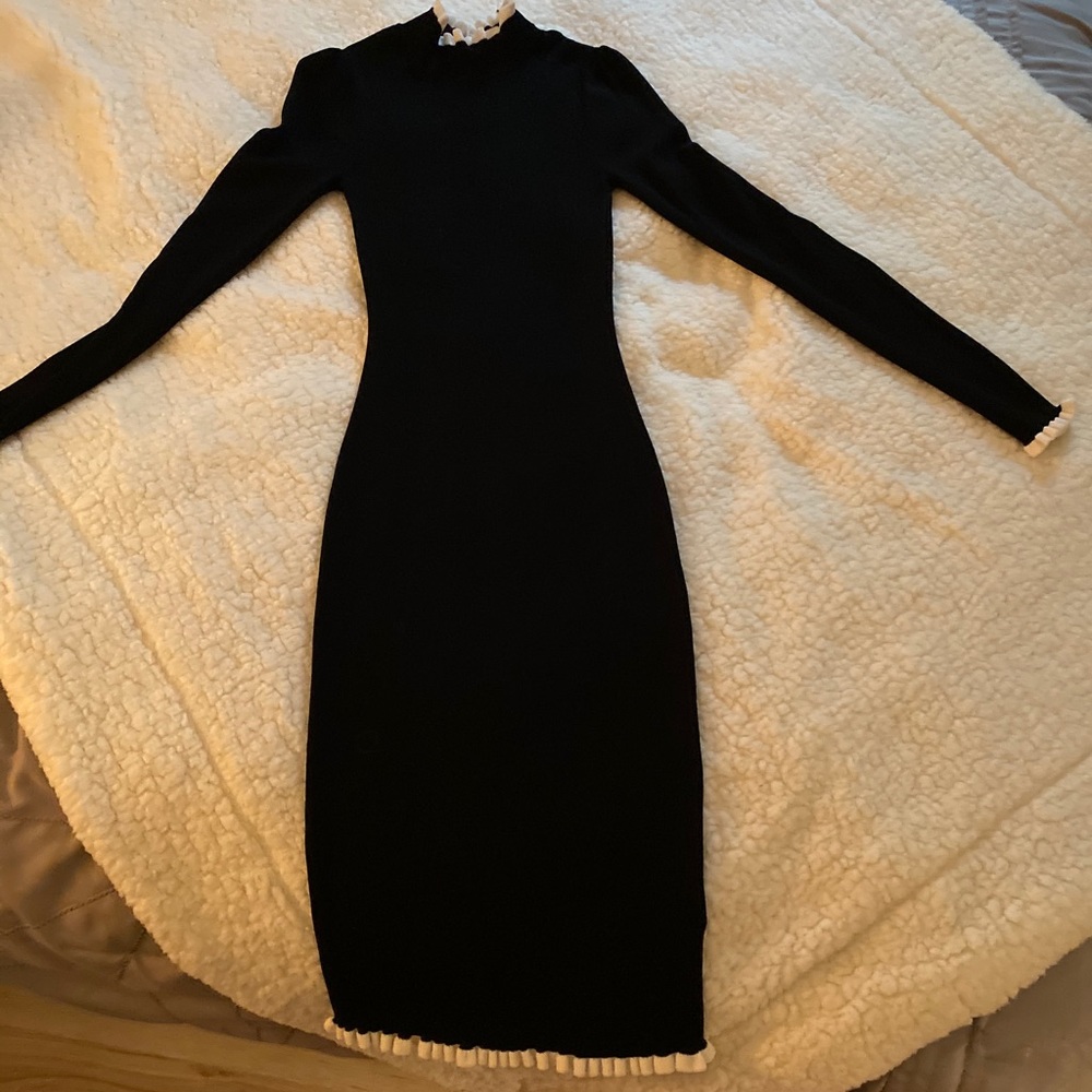 Black dress with cream trim on neck, sleeve